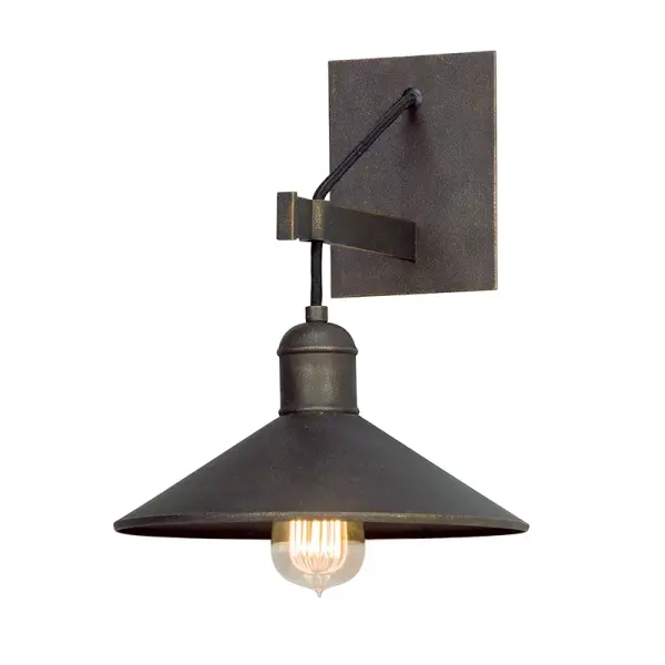 The McCoy wall sconce brings authentic industrial style with hand-worked iron construction and vintage bronze finish. Its compact 10-inch profile makes it ideal for smaller spaces while delivering substantial visual impact.