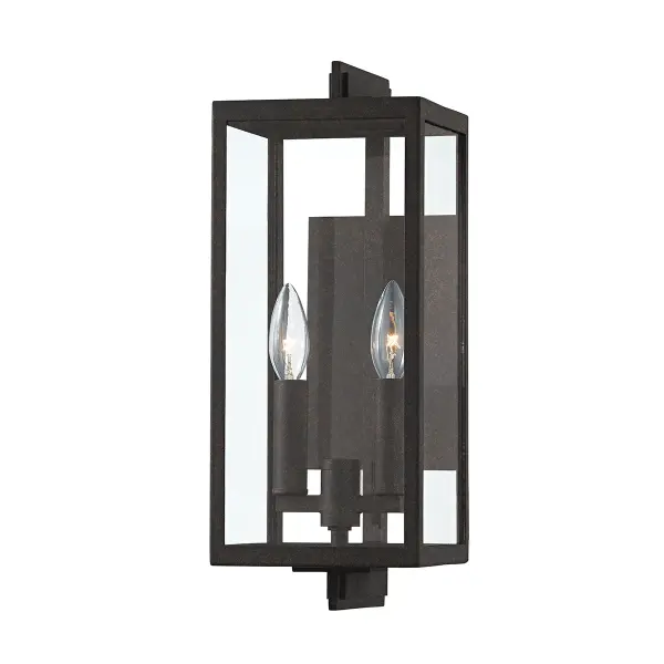 The Nico outdoor wall sconce blends contemporary design with industrial charm through its dimensional French Iron cage and c-bracket construction. Wet-rated for durability and compact at 16 inches tall.