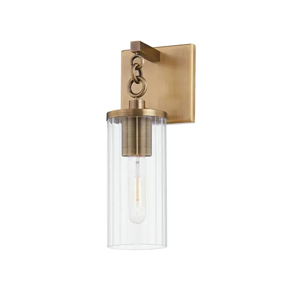 The Yucca wall sconce combines decorative sophistication with outdoor durability. Its patina brass finish and delicate chain detail create visual interest, while the fluted clear glass shade and wet-rated construction ensure reliable performance in any weather.