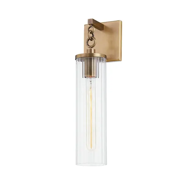 The Yucca wall sconce brings refined style to outdoor spaces with its patina brass finish and delicate chain detail. The fluted clear glass shade and dual-arm mounting provide both visual interest and structural stability for weather resistance.