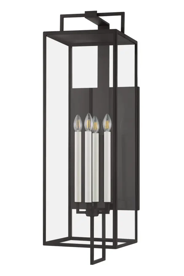 The Beckham sconce delivers commanding presence for large-scale exteriors with its elongated 40-inch silhouette. Four candelabra bulbs provide ambient illumination through clear glass panels, while the forged iron finish adds old-world character.