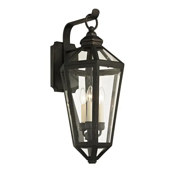 The Calabasas wall lantern brings traditional elegance to outdoor spaces with hand-worked iron construction and clear glass panels. Its wet-rated design and substantial 25.5-inch height make it ideal for entryways and porches.