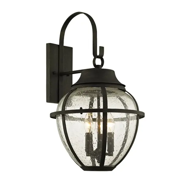 The Bunker Hill wall lantern combines traditional design with hand-worked iron craftsmanship. Its vintage bronze finish and clear glass panels create warm, welcoming illumination for exterior spaces while meeting wet location safety standards.