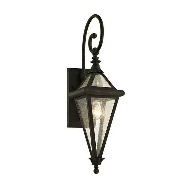The Geneva Wall Lantern combines vintage-inspired design with premium hand-worked iron construction. Its wet-rated certification and concealed mounting hardware deliver both style and function for exterior spaces.