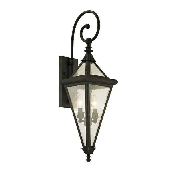 The Geneva wall lantern combines sleek vintage aesthetics with premium hand-worked iron construction. Features exacting step details on metal rings and dual-layer glass for polished appearance and even light diffusion.