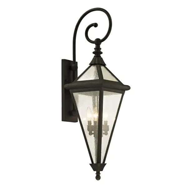 The Geneva wall lantern combines vintage aesthetics with modern durability. Hand-worked iron construction and heavy opal glass create a sophisticated outdoor lighting solution that's both functional and beautiful.