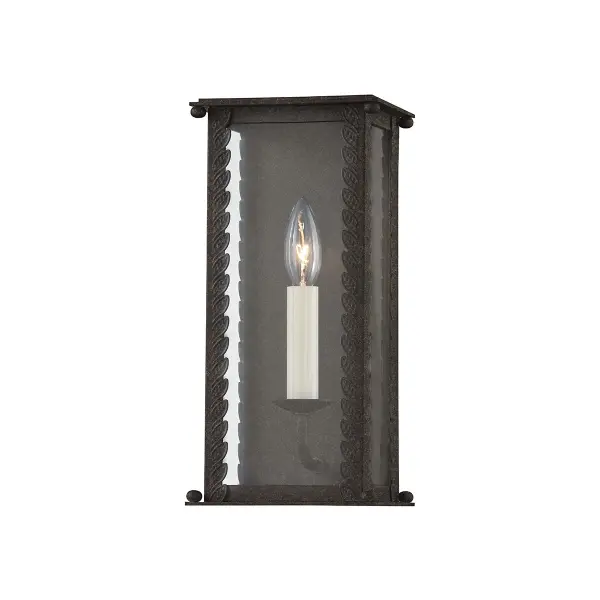 The Zuma wall sconce brings organic elegance to outdoor spaces with its candelabra-style cage featuring climbing leaf details and demure corner finials. Clear glass showcases the candlestick light while wet-rated construction ensures durability.