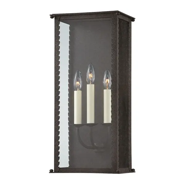 The Zuma outdoor wall sconce brings organic elegance to exterior spaces with its delicate leaf detailing and candelabra-style design. Clear glass showcases the candlestick lights while the French iron finish adds timeless appeal.