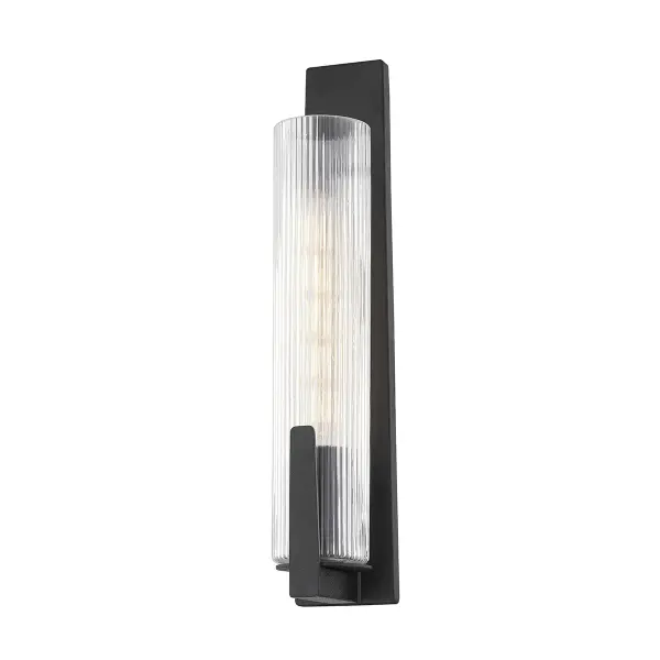The Malakai wall sconce delivers modern sophistication with its slender silhouette and ribbed glass tube shade. The forged iron finish and clear optic glass create a refined look perfect for contemporary bathrooms and hallways.