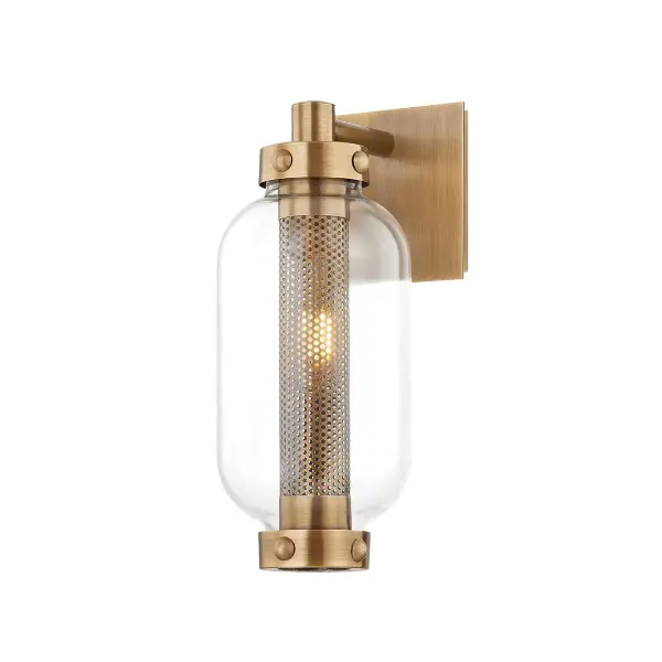 The Atwater wall sconce combines industrial style with coastal charm through its perforated brass design and exposed hardware. Wet-rated for durability in any outdoor setting, it creates a soft, striking glow perfect for coastal and modern exteriors.