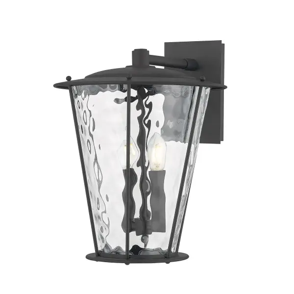 The Jantzen wall sconce reimagines traditional lantern styling with angled edges and wavy water glass that adds visual interest. The textured black finish provides durability and timeless appeal for exterior applications.