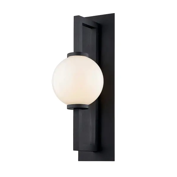 The Darwin wall sconce combines hand-crafted aluminum construction with a striking textured black finish and opal glass shade. Its substantial 29.5-inch height makes a dramatic statement on exterior walls while meeting wet location safety standards.