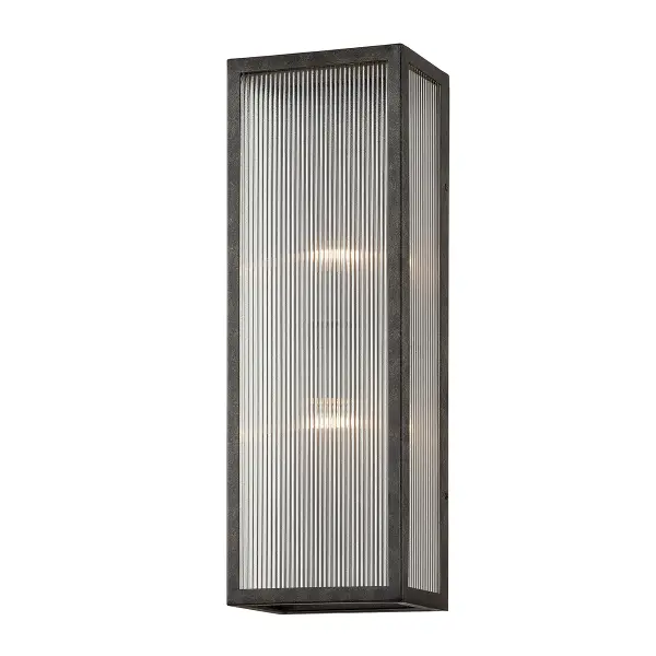 The Tisoni outdoor wall sconce combines traditional elegance with industrial durability. Hand-crafted aluminum construction with French Iron finish and clear ribbed glass creates visual interest while providing reliable outdoor illumination.