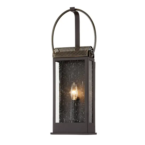 The Holmes wall sconce combines traditional styling with hand-crafted aluminum construction and clear seeded glass. Its wet-rated certification and compact 7.75" profile make it ideal for exterior applications.