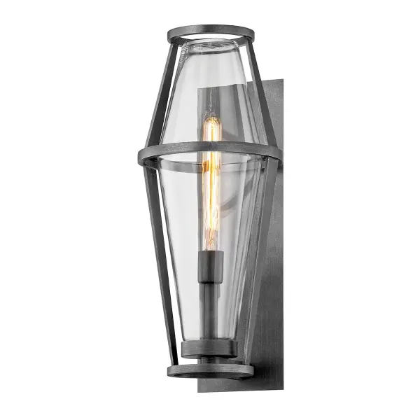 The Prospect wall sconce combines industrial-inspired design with weather-resistant construction. Its hand-crafted aluminum frame in graphite finish and clear glass shade deliver both style and function for exterior applications.