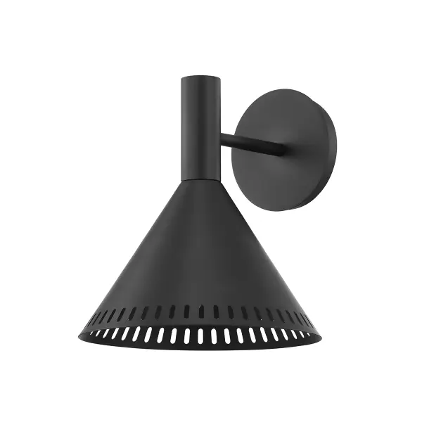 The Atticus wall sconce blends mid-century modern aesthetics with industrial charm through its vintage beaker-inspired shape and perforated metal shade. Light filters through the perforations creating ambient glow while illuminating downward for functional task lighting.