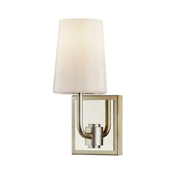 The Simone bath sconce combines artisanal craftsmanship with refined elegance. Its hand-worked iron construction and warm silver leaf finish create a sophisticated look, while the opal glossy glass provides soft, flattering illumination ideal for vanity applications.