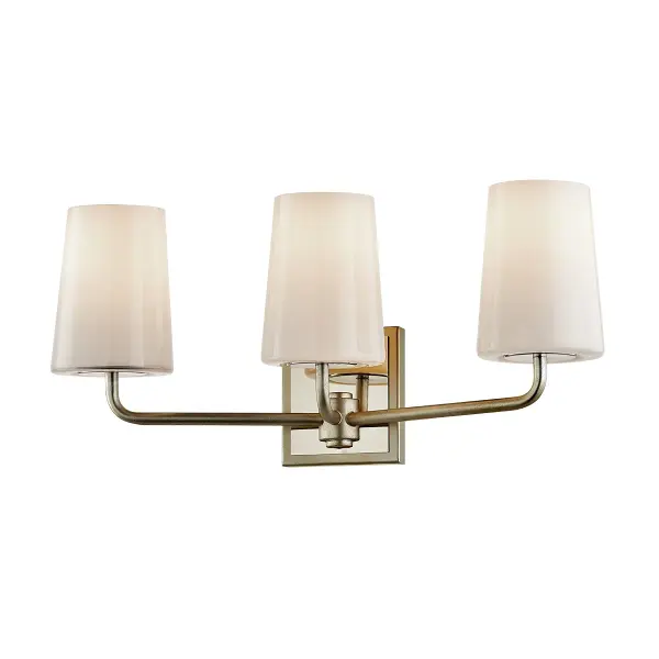 The Simone three-light vanity fixture combines artisanal craftsmanship with transitional design. Hand-worked iron in a warm silver leaf finish pairs beautifully with opal glossy glass shades for soft, flattering bathroom lighting.
