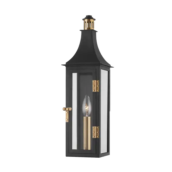 The Wes sconce elevates the traditional lantern with a slim, elongated profile and sophisticated Patina Brass and Texture Black finish. Hinges and knob detailing add artisanal character while the wet-rated design ensures durability.