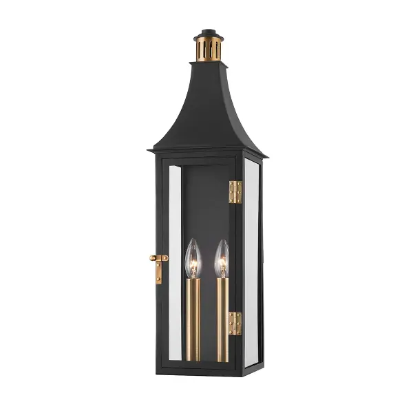 The Wes sconce elevates traditional lantern design with a slim profile, elongated silhouette, and stylized metal detailing. The Patina Brass and Texture Black two-tone finish adds visual interest while the wet-rated construction ensures durability.
