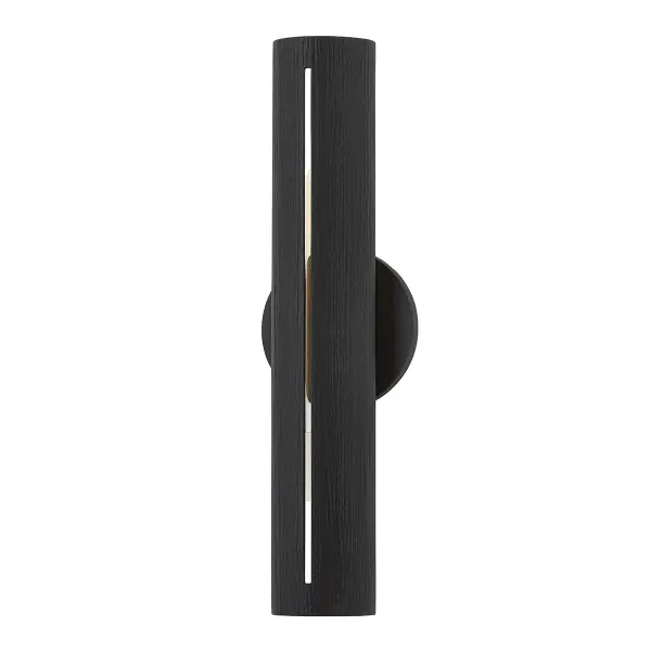 The Brandon sconce delivers modern sophistication with its slim vertical profile and textured black finish. At under 18 inches tall and just over 3 inches wide, it's ideal for tight spaces requiring focused task lighting.