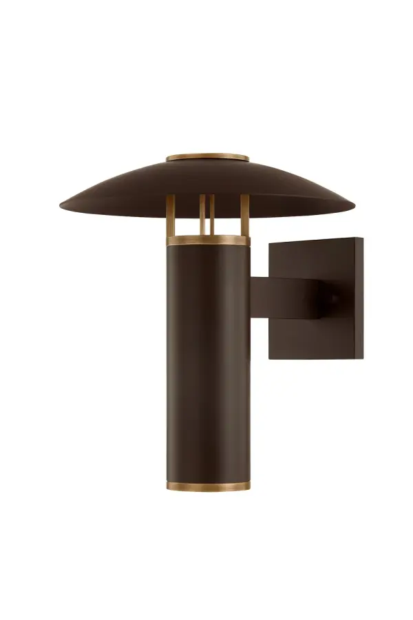 The Birk wall sconce blends vintage industrial design with modern functionality. Its shallow dome shade and patina brass finish create warm, downward-focused light perfect for exterior entryways and patios.