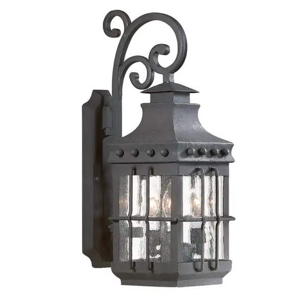 The Dover wall lantern combines traditional styling with hand-forged iron construction and clear seeded glass. Its compact 7.75" width and wet-rated certification make it ideal for exposed outdoor locations.