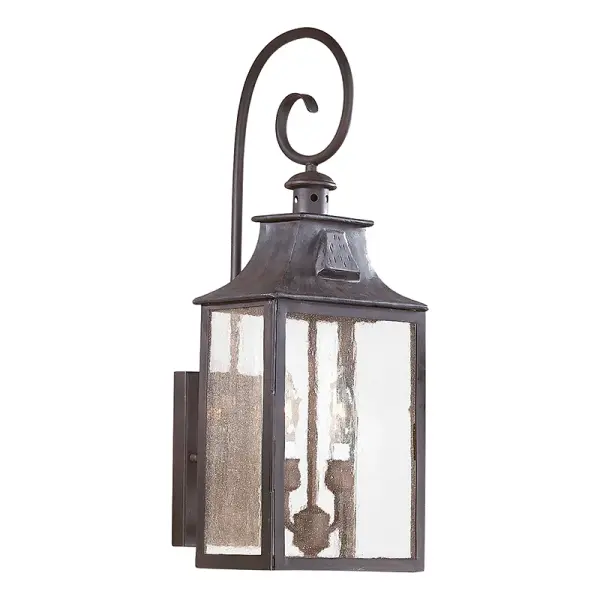 The Newton wall lantern combines traditional craftsmanship with durable outdoor construction. Hand-forged iron in a soft off black finish creates an authentic, artisanal look that complements both classic and transitional exteriors.