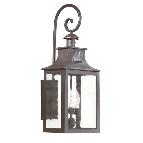 The Newton wall lantern combines traditional craftsmanship with modern durability. Hand-forged iron construction and clear seeded glass create authentic character, while wet-rated certification ensures reliable outdoor performance.