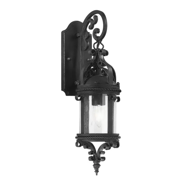 The Pamplona wall lantern brings Old World charm to exterior spaces with hand-forged iron construction and clear seeded glass. Its compact 6.25" profile fits tight spaces while the wet-rated design ensures durability in all weather conditions.