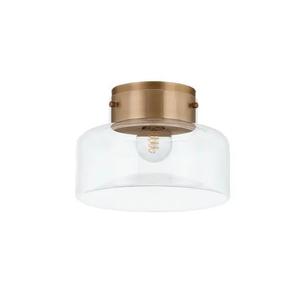 The Bellow flush mount creates visual tension through its concave-convex glass interplay. The dimpled, etched lower surface diffuses light beautifully while the patina brass finish adds warmth to contemporary interiors.