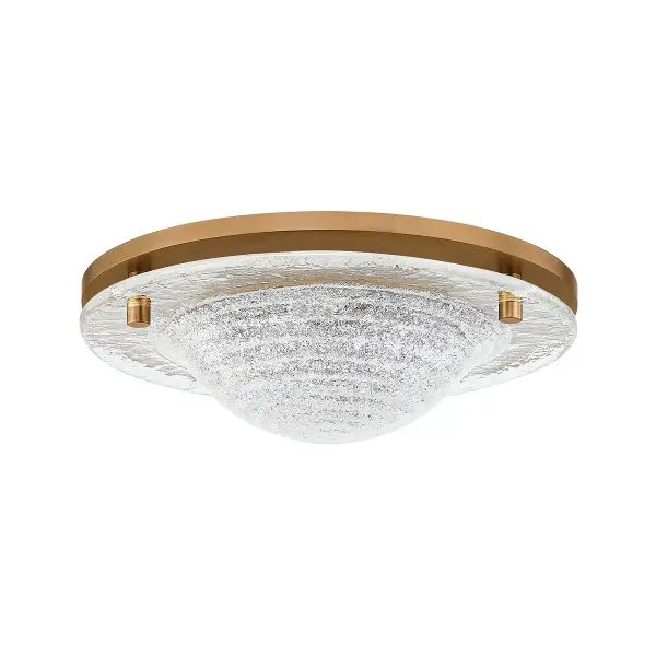 The Halston transforms a utilitarian flush mount into a design statement with its distinctive cast piastre glass featuring concentric ring patterns. The integrated LED provides efficient, warm illumination while the Patina Brass framework adds luxurious warmth.