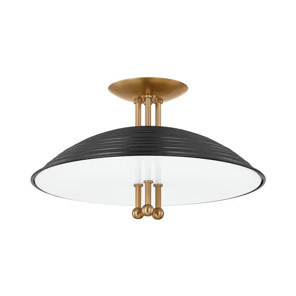 The Larkin semi-flush mount makes a dramatic statement with its graphic industrial aesthetic. The large soft black dome shade contrasts beautifully with the milky white glass diffuser, while three patina brass rods pierce through the fixture like jewelry, creating a distinctive modern look.