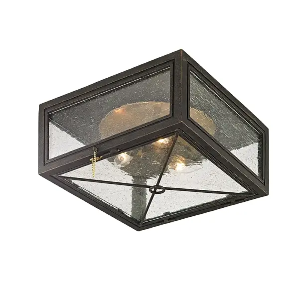 The Randolph flush mount brings industrial character to low-ceiling spaces with its hand-crafted iron and brass construction. Clear seeded glass adds texture while the vintage bronze finish provides warmth and versatility.