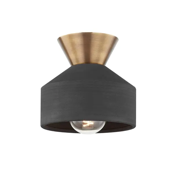 The Covina flush mount combines a matte Ceramic Black shade with warm Patina Brass metalwork for a sophisticated organic aesthetic. Its compact 7.75-inch size makes it ideal for smaller spaces requiring stylish overhead lighting.