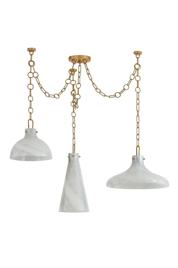 The Joaquin transforms spaces with its sculptural three-pendant design and unique Luna glass shades featuring grey-white marbling. Field-configurable installation allows creative spatial arrangements, while patina brass accents add warmth.