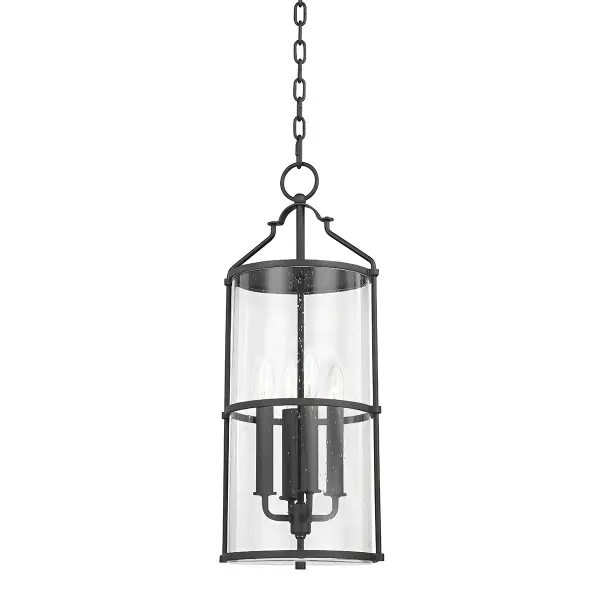The Burbank outdoor lantern brings old-world charm to exterior spaces with its decorative steeple-inspired handle and clear seeded glass. The textured black aluminum frame offers durability and weather resistance while maintaining elegant proportions.
