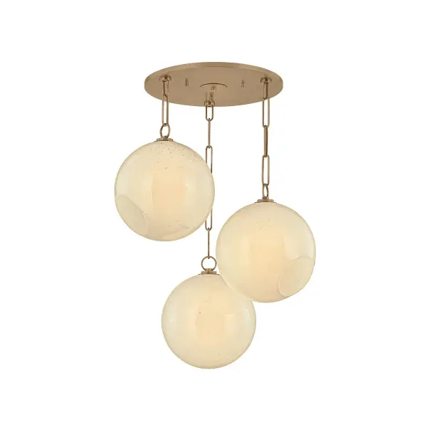 The Bramble chandelier stands out with its intentionally off-axis globe arrangement, creating visual interest and directing light dynamically. The patina brass finish adds warmth while the seeded cloud glass provides soft, diffused illumination.