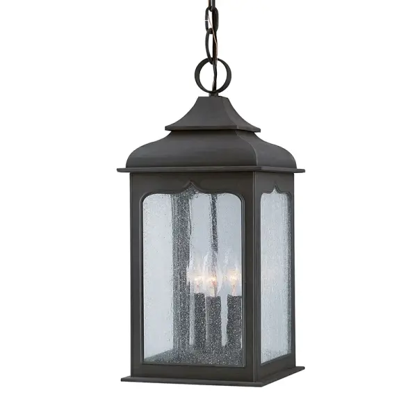 The Henry Street lantern brings traditional charm to outdoor spaces with hand-forged iron construction and clear seeded glass. Its compact 9-inch width makes it ideal for porches and entryways without overwhelming the space.