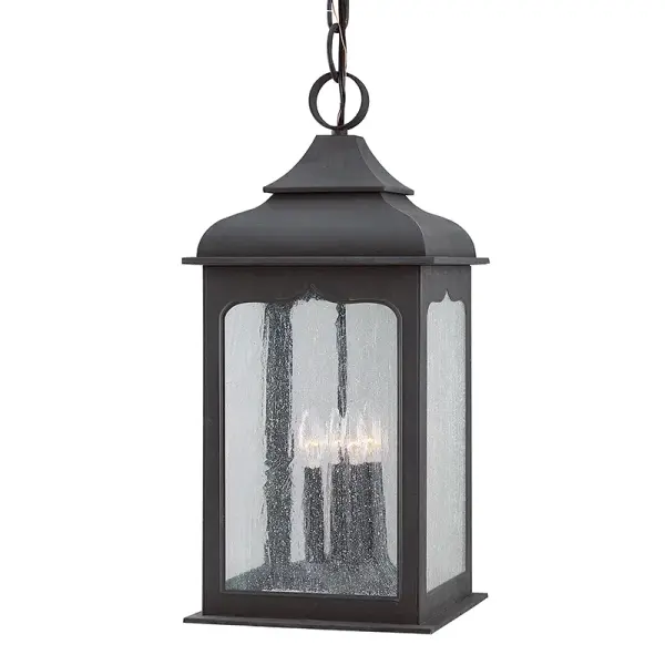 The Henry Street lantern brings traditional charm to outdoor spaces with hand-forged iron construction and clear seeded glass. Its compact 11" profile works beautifully in covered porches and entryways while providing ample illumination.