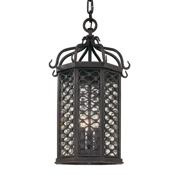 This handcrafted hanging lantern brings Old World charm to outdoor spaces with its textured iron finish and clear glass panels. The compact 11.75" width makes it ideal for smaller porches and entryways while providing ample illumination through three candelabra bulbs.