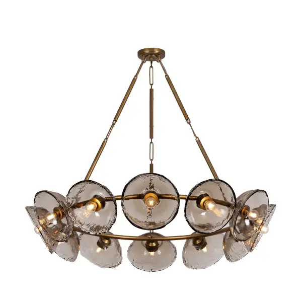 Diego reimagines the classic ring chandelier with 12 hand-crafted piastre glass shades arranged concentrically around a patina gold leaf frame. Each dish-shaped shade creates a luminous halo effect around petite exposed bulbs, blending industrial structure with ethereal glasswork for a striking statement piece.