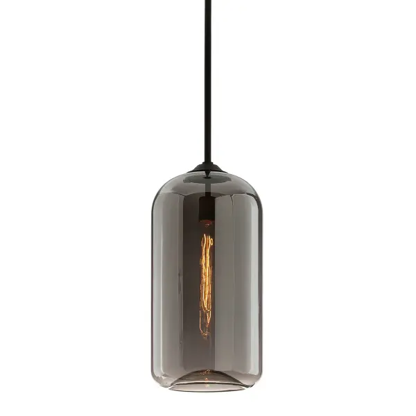 The District pendant blends industrial authenticity with refined craftsmanship. Hand-blown smoke glass and hand-worked iron create a sophisticated take on warehouse lighting, while the concave base detail adds ambient glow.
