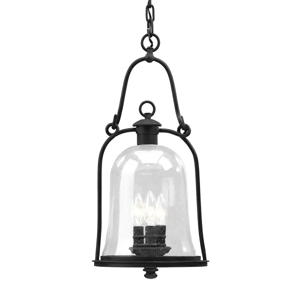 The Owings Mill lantern combines traditional craftsmanship with durable hand-forged iron construction. Its textured black finish and clear seeded glass create warm, inviting illumination perfect for covered outdoor areas.
