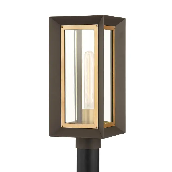 The Lowry post mount combines textured bronze aluminum with patina brass accents and clear beveled glass for a refined outdoor lighting solution. Its compact 7.5-inch profile delivers upscale style without overwhelming smaller spaces.