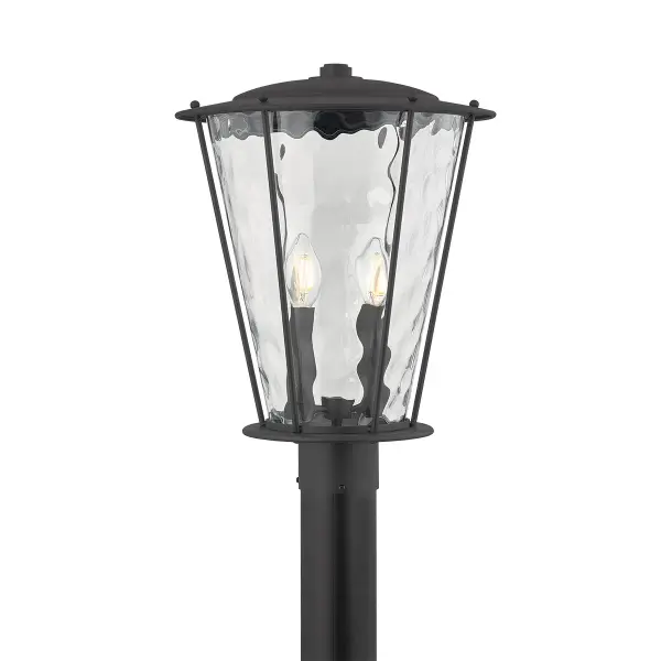The Jantzen post mount reimagines traditional lantern styling with angled edges and wavy water glass that adds visual texture. The textured black finish provides durability while cream candle sleeves brighten the design.