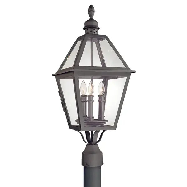 The Townsend post lantern combines traditional design with durable hand-worked iron construction. Its wet-rated certification and clear glass panels make it ideal for exposed outdoor locations requiring reliable illumination.