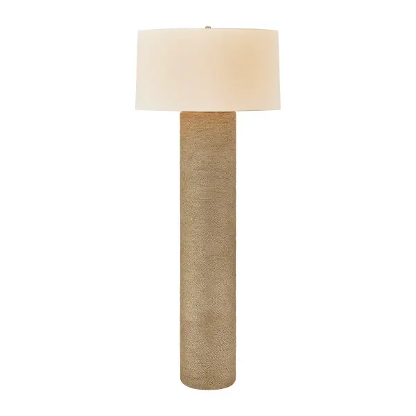 The Roan floor lamp brings organic elegance with its cylindrical base wrapped in bleached jute rope. The natural fiber texture paired with patina brass hardware creates a sophisticated coastal-modern aesthetic that works beautifully in contemporary and transitional spaces.