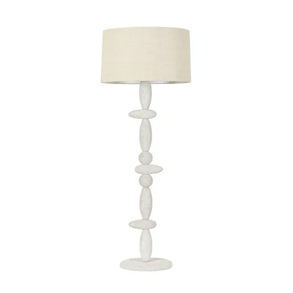 The Cullen floor lamp brings architectural drama with its totemic ceramic form and vintage gold finish. Designer Chandler McLellan's intentionally off-center stone placement creates organic tension while the circular metal backplate adds modern contrast.