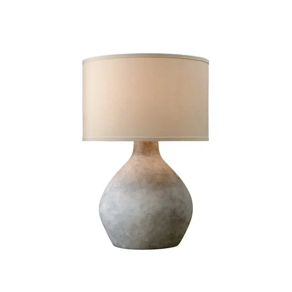 The Zen table lamp brings organic elegance with its dimensional alabastrino ceramic finish and natural linen shade. Its substantial presence and calming aesthetic make it ideal for creating peaceful, sophisticated spaces.